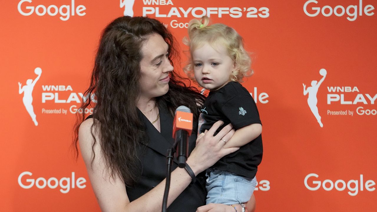 New York Liberty forward Breanna Stewart holds her daughter Ruby while speaking to reporters, Sept. 26, 2023, at Barclays Center in New York. (AP Photo/Mary Altaffer, File)