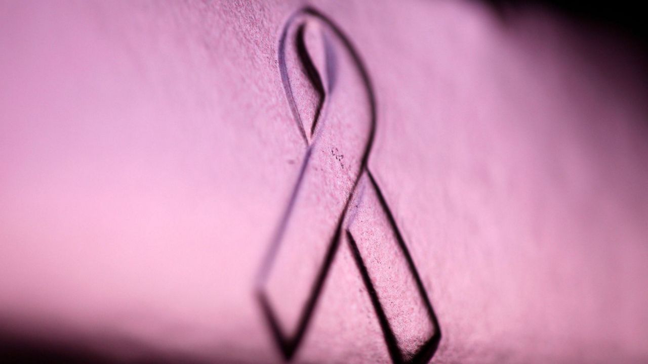 A photo of a breast cancer awareness ribbon. 