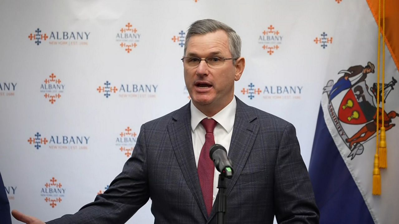 former albany police chief brendan cox speaks at press conference in suit