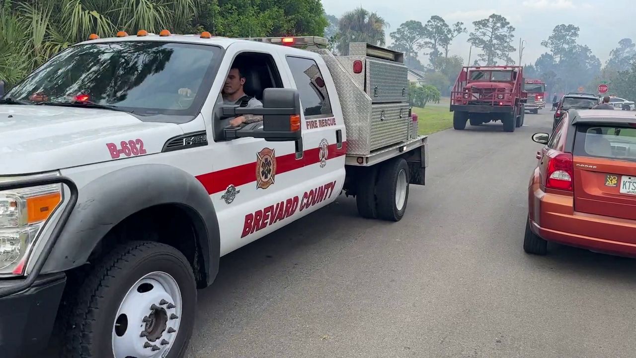 Fire vehicles drive through an area of Palm Bay that experienced a threat of brush fire Saturday. (Spectrum News/Christopher Krul)