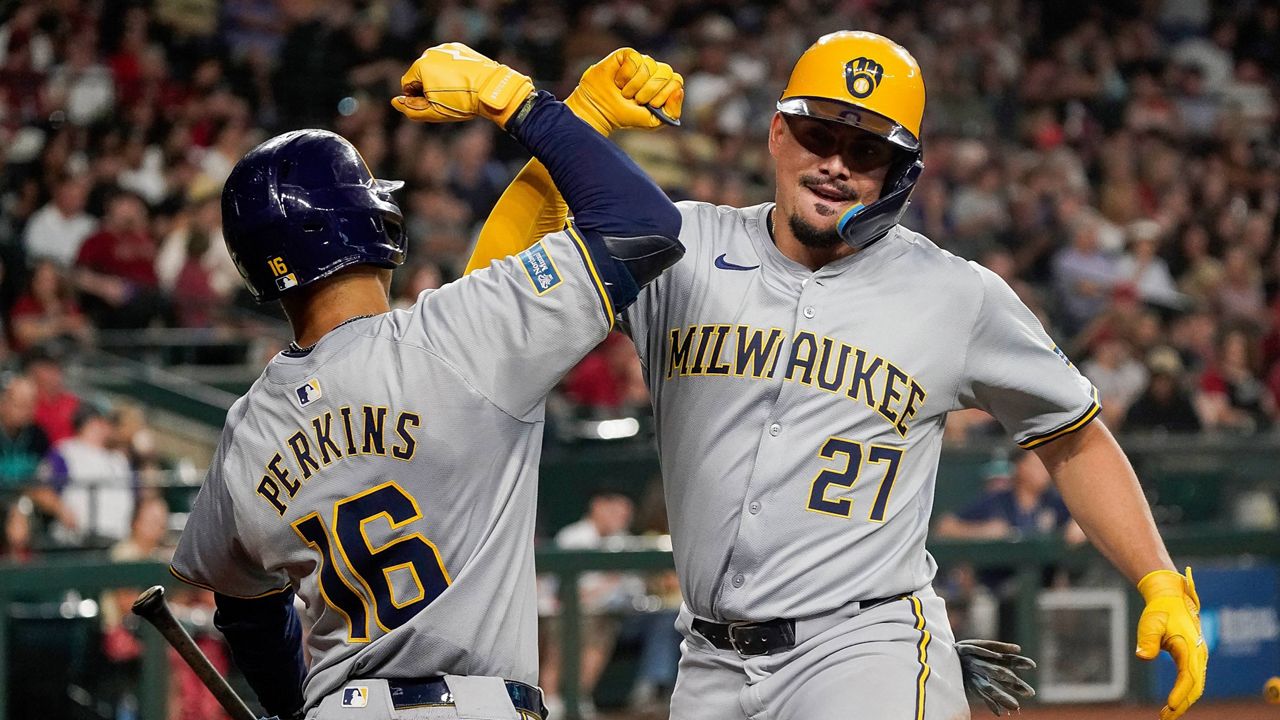 Milwaukee Brewers' Willy Adames, right, celebrates after his second home run against the Arizona Diamondbacks with Blake Perkins (16) during the fourth inning of a baseball game, Saturday, Sept. 14, 2024, in Phoenix. (AP Photo/Darryl Webb)