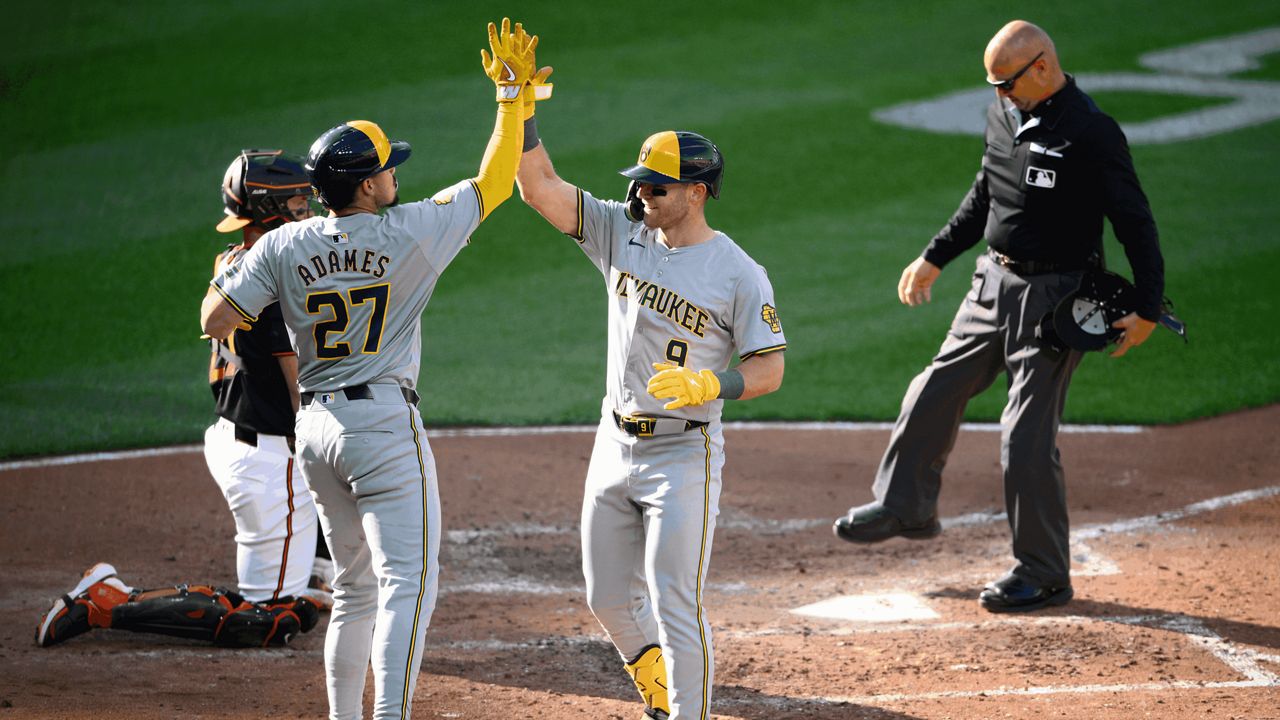 Milwaukee Brewers' Jake Bauers (9) celebrates his three-run home run with Willy Adames