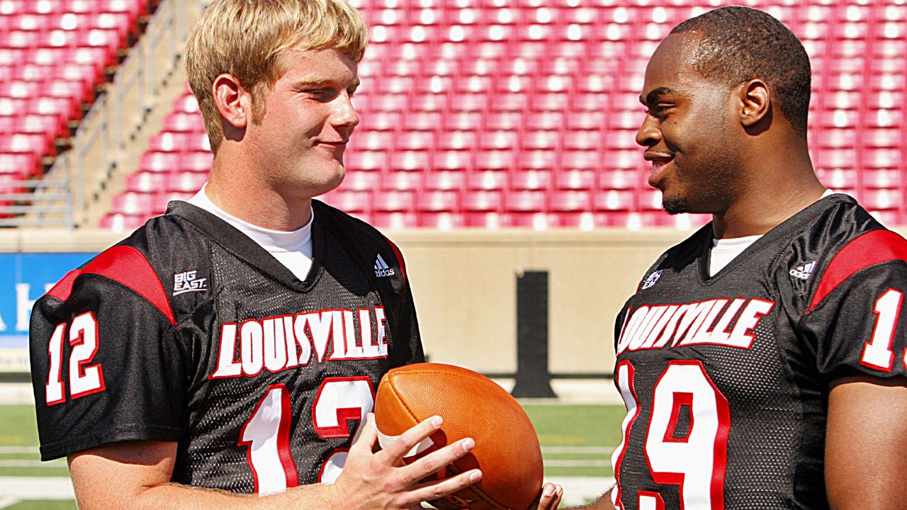 Louisville quarterback Brian Brohm, left, jokes around with senior running back Michael Bush, right, during picture day at Cardinal Stadium in Louisville, Ky., Saturday, Aug. 5, 2006. (AP Photo/Garry Jones)