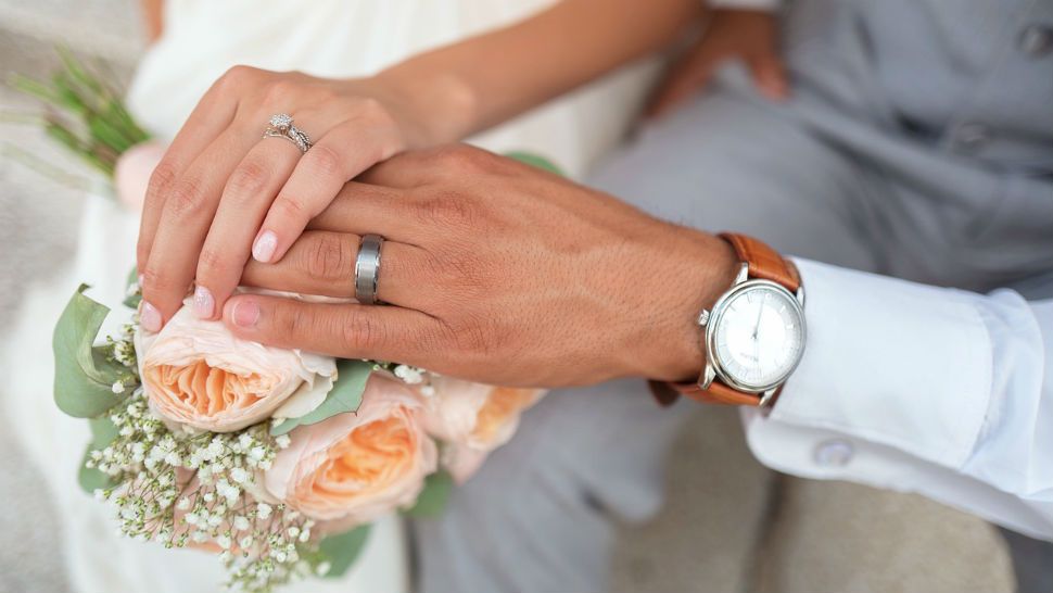 A bride and groom holding hands. (Spectrum News/File)