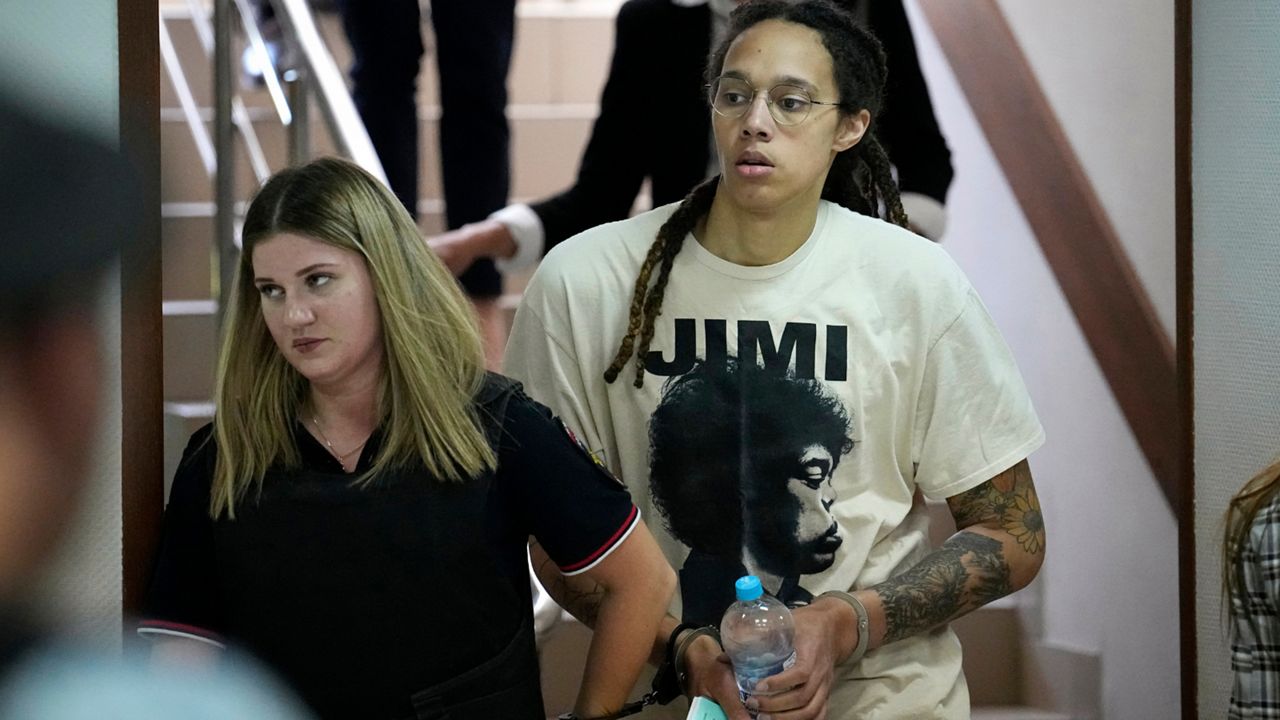 WNBA star and two-time Olympic gold medalist Brittney Griner is escorted to a courtroom for a hearing, in Khimki just outside Moscow, Russia, Friday, July 1, 2022. U.S. basketball star Brittney Griner is set to go on trial in a Moscow-area court Friday. The proceedings that are scheduled to begin Friday come about 4 1/2 months after she was arrested on cannabis possession charges at an airport while traveling to play for a Russian team. (AP Photo/Alexander Zemlianichenko)