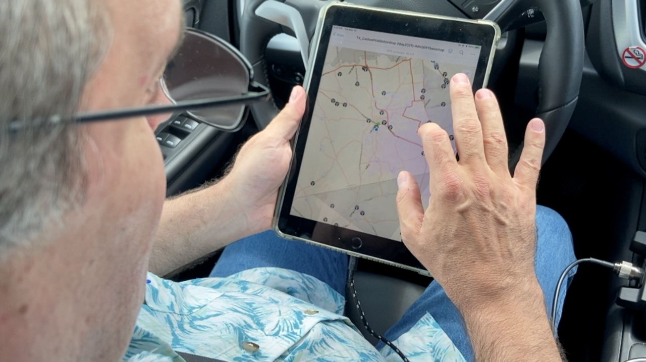 Charles “Chip” Spann looks over a broadband access map in this image from June 2021. (Spectrum News 1/Matthew Mershon)