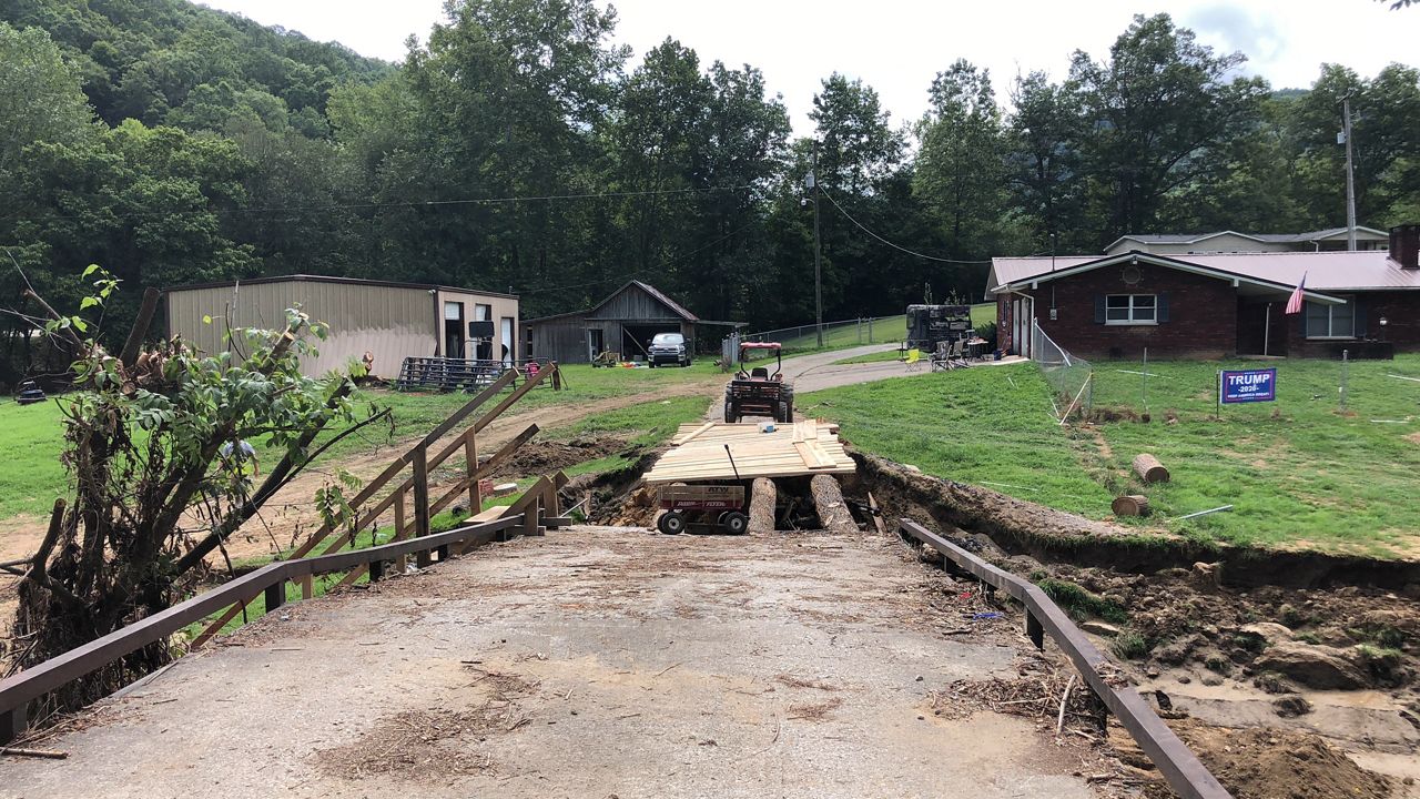 Broken bridges across eastern Kentucky have cut off access to either the main road or homes. A Knott County man began building a temporary bridge to create a path. (Spectrum News 1/Khyati Patel)