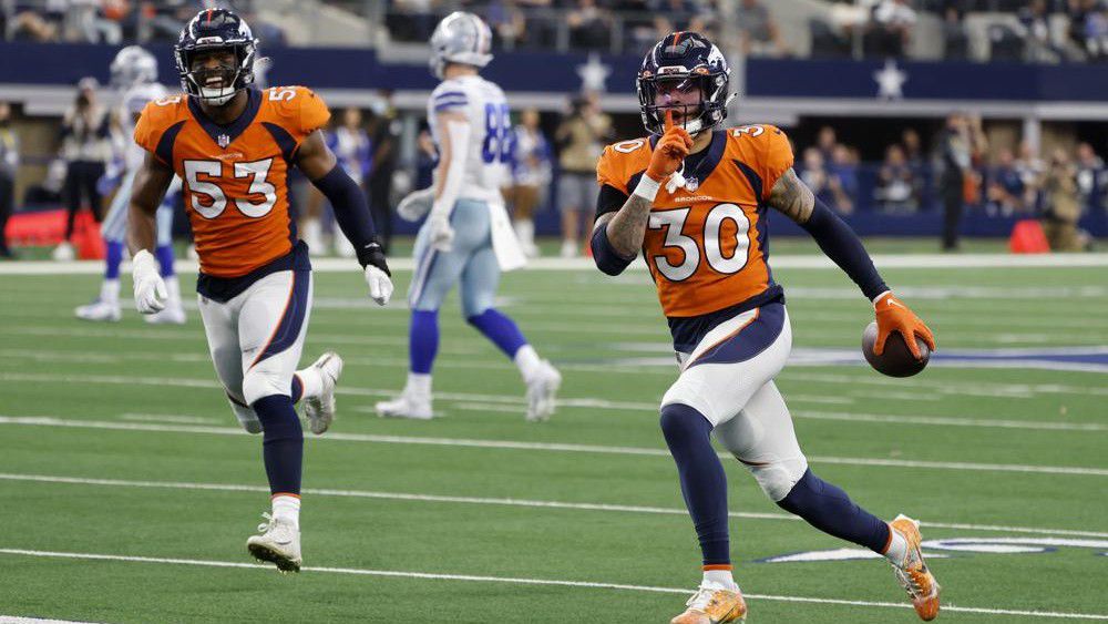Denver Broncos' Jonathon Cooper (53) and safety Caden Sterns (30) celebrate after Sterns intercepted a pass thrown by Dallas Cowboys' Dak Prescott in the second half of an NFL football game in Arlington, Texas, Sunday, Nov. 7, 2021. (AP Photo/Michael Ainsworth)
