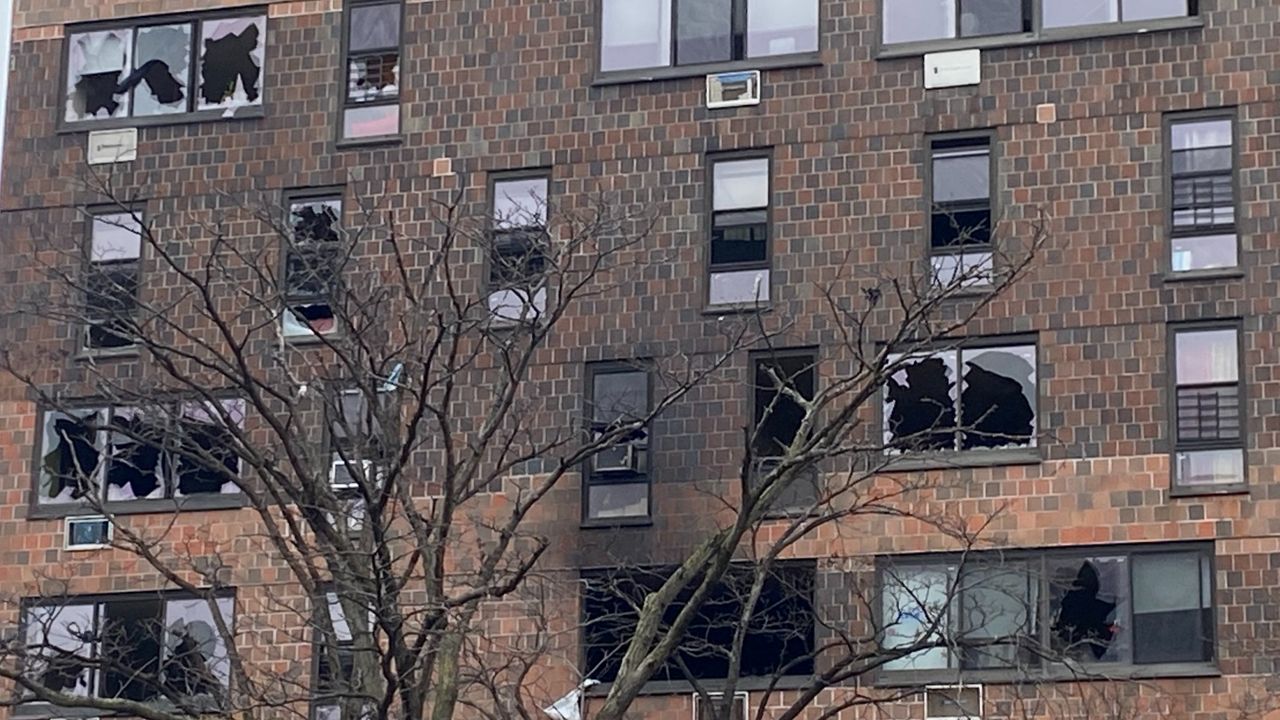 The fire blew out windows across the building's facade. (NY1/Ron Lee)