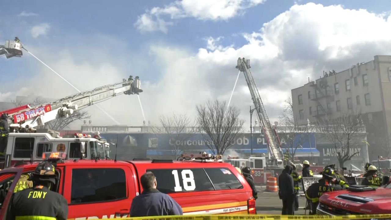 Firefights extinguish a five-alarm fire at the Concourse Food Plaza in Fordham Heights on March 5, 2023.