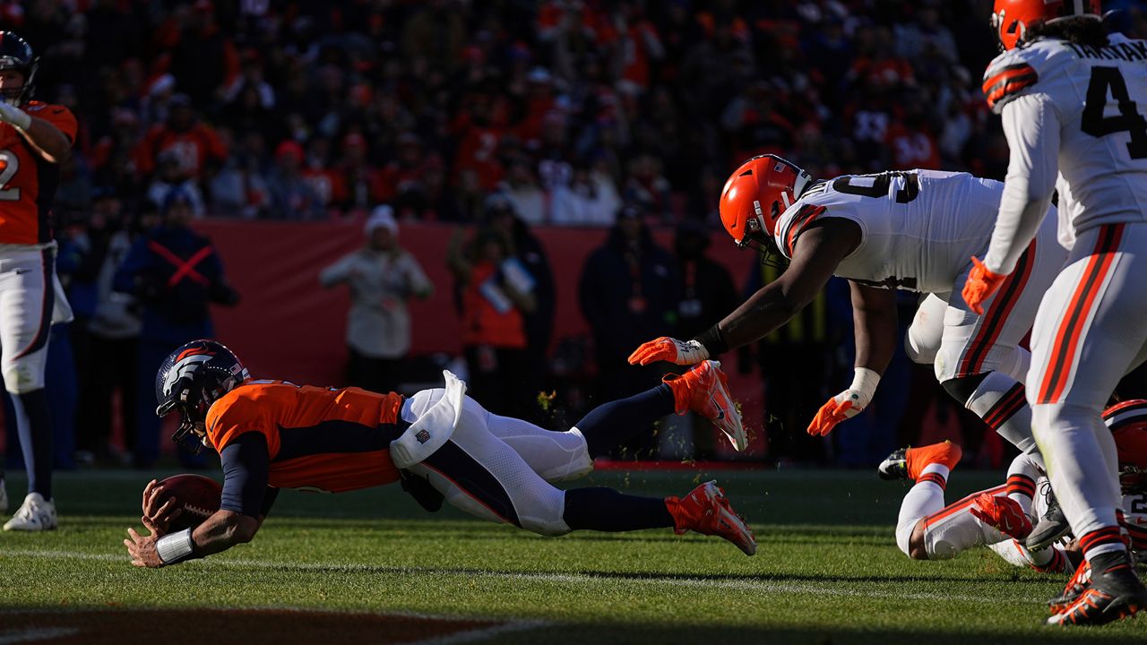 Denver Broncos quarterback Russell Wilson (3) scores a touchdown against the Cleveland Browns of an NFL football game Sunday November 26, 2023, in Denver. (AP Photo/Bart Young)