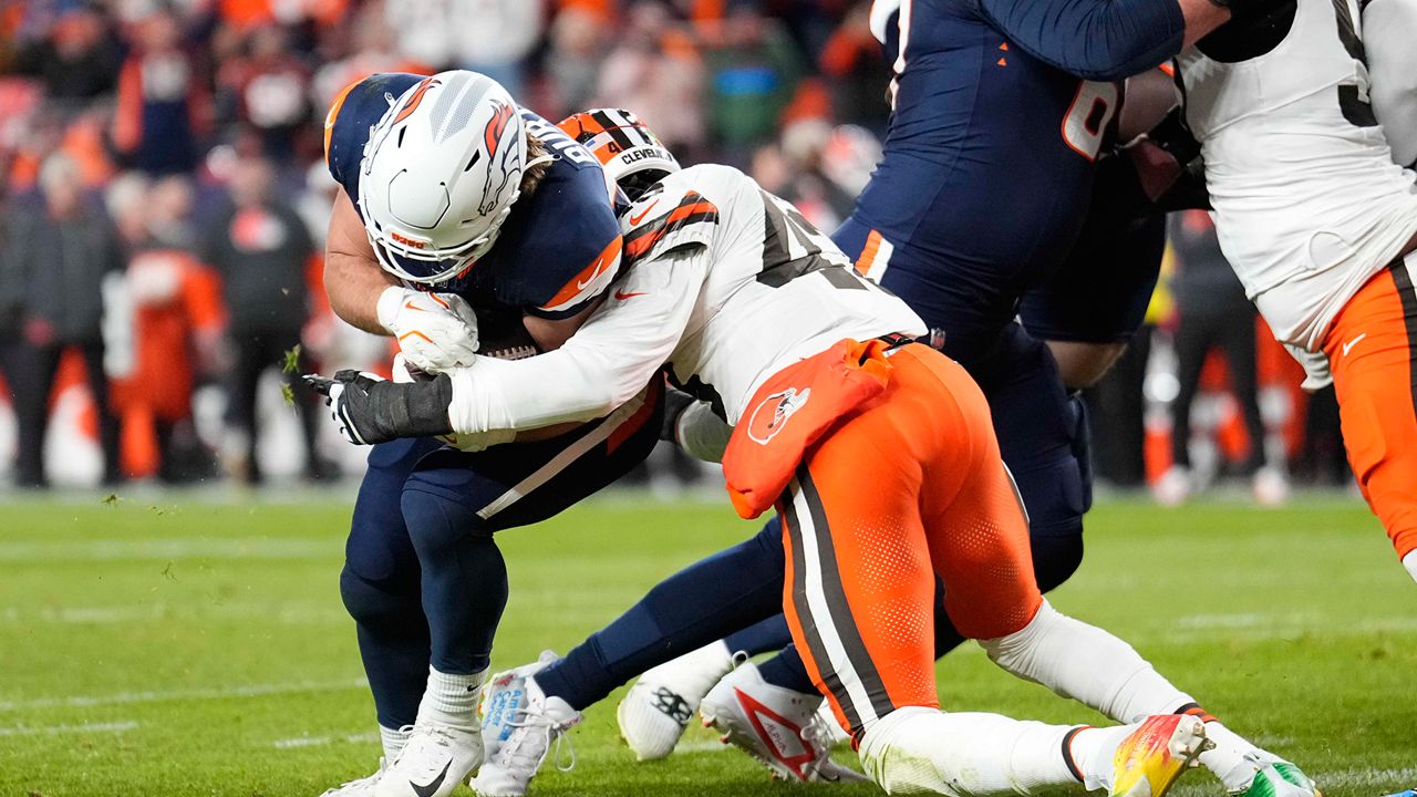 Denver Broncos fullback Michael Burton (20) breaks from Cleveland Browns linebacker Mohamoud Diabate (43) to score from 1-yard during the first half of an NFL football game, Monday, Dec. 2, 2024, in Denver. (AP Photo/Jack Dempsey)