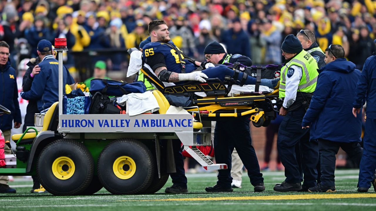 Michigan offensive lineman Zak Zinter is carted off the field after sustaining an injury during the second half of an NCAA college football game against Ohio State Nov. 25, 2023, in Ann Arbor, Mich.