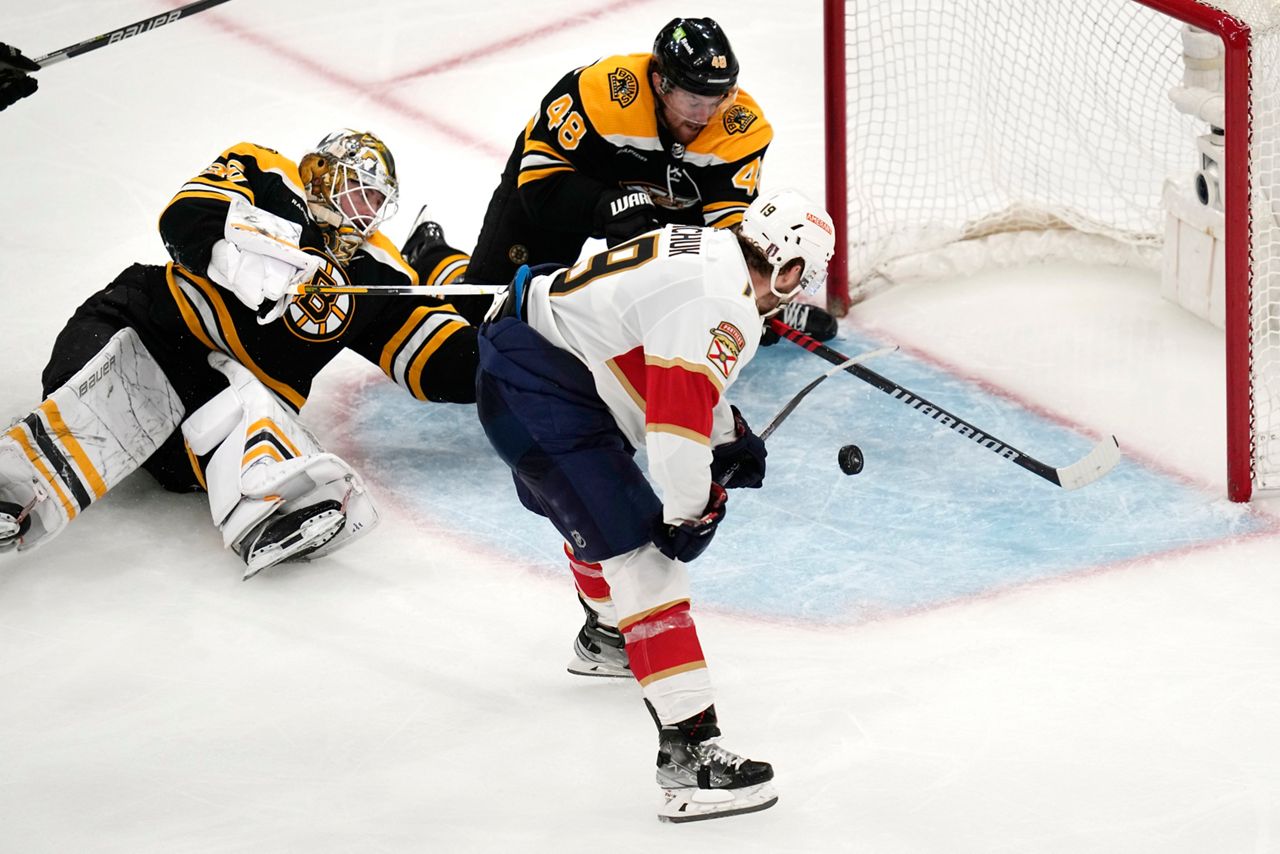 Florida Panthers left wing Matthew Tkachuk (19) shoots the puck past Boston Bruins goaltender Linus Ullmark and defenseman Matt Grzelcyk (48) while scoring the game-winning goal during overtime of Game 5 in the first round of the NHL hockey playoffs, Wednesday, April 26, in Boston. (AP Photo/Charles Krupa)