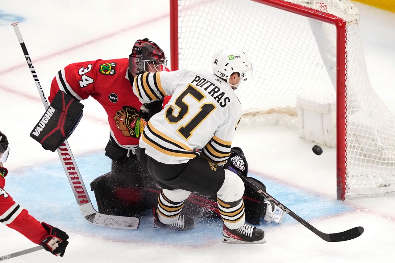 Boston Bruins' Matthew Poitras scores past Chicago Blackhawks goaltender Petr Mrazek during the third period of an NHL hockey game Tuesday, Oct. 24, 2023, in Chicago. (AP Photo/Charles Rex Arbogast)