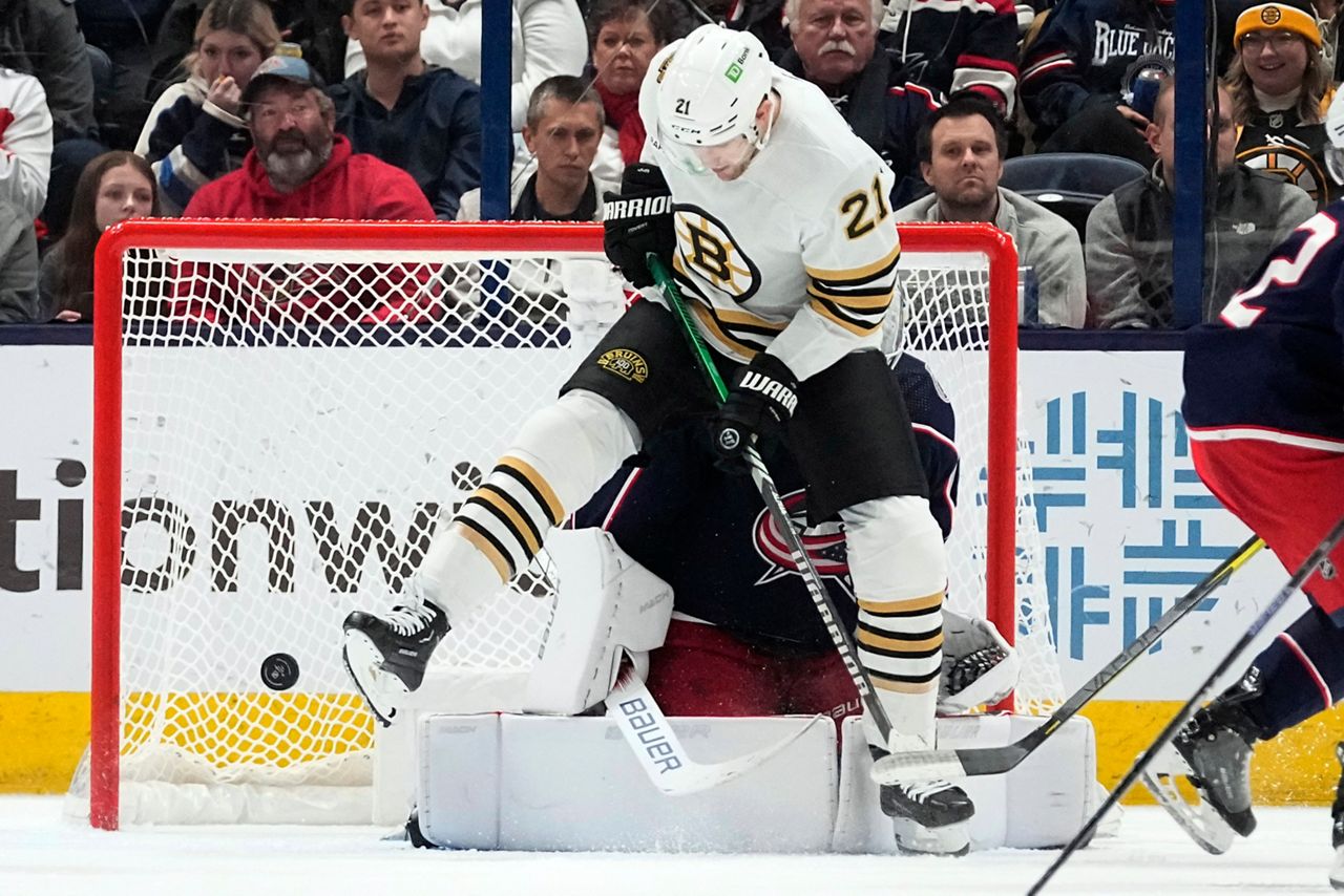 Boston Bruins left wing James van Riemsdyk (21) jumps out of the way of a shot in front of Columbus Blue Jackets goaltender Spencer Martin in the second period of an NHL hockey game Tuesday, Jan. 2, 2024, in Columbus, Ohio. (AP Photo/Sue Ogrocki)