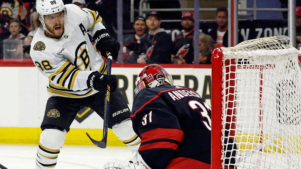Boston Bruins' David Pastrnak (88) slips the puck past Carolina Hurricanes goaltender Frederik Andersen (31) into the top of the net while for a goal during the first period of an NHL hockey game in Raleigh, N.C., Thursday, April 4, 2024. (AP Photo/Karl B DeBlaker)