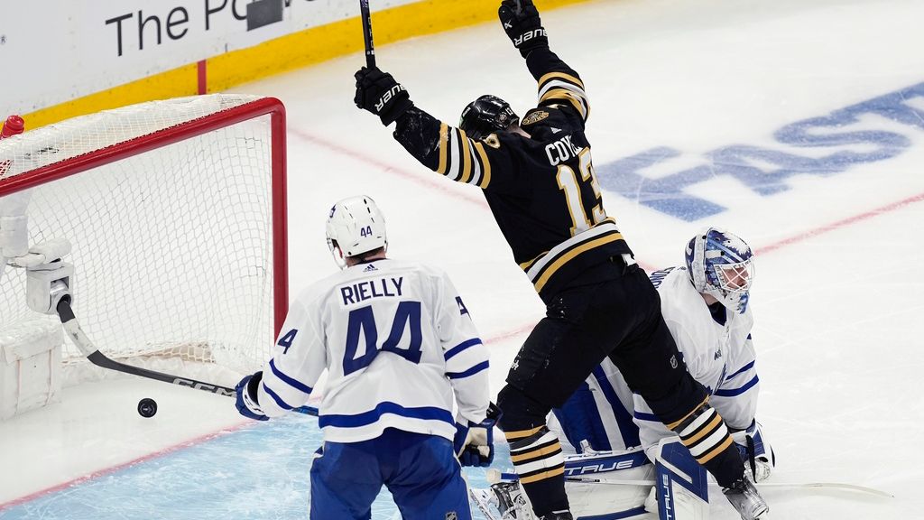 Boston Bruins' Charlie Coyle (13) celebrates a goal by Brandon Carlo against Toronto Maple Leafs goalie Ilya Samsonov, right, during the second period in Game 1 of an NHL hockey Stanley Cup first-round playoff series Saturday, April 20, 2024, in Boston. (AP Photo/Michael Dwyer)