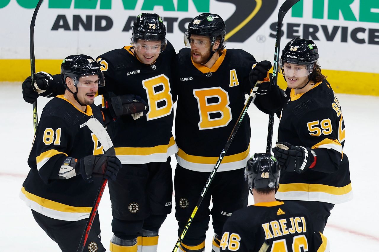 Boston Bruins' David Pastrnak (88) celebrates his goal with Dmitry Orlov (81), Charlie McAvoy (73), Tyler Bertuzzi (59) and David Krejci (46) during the third period of an NHL hockey game against the New York Rangers, Saturday, March 4, in Boston. (AP Photo/Michael Dwyer)