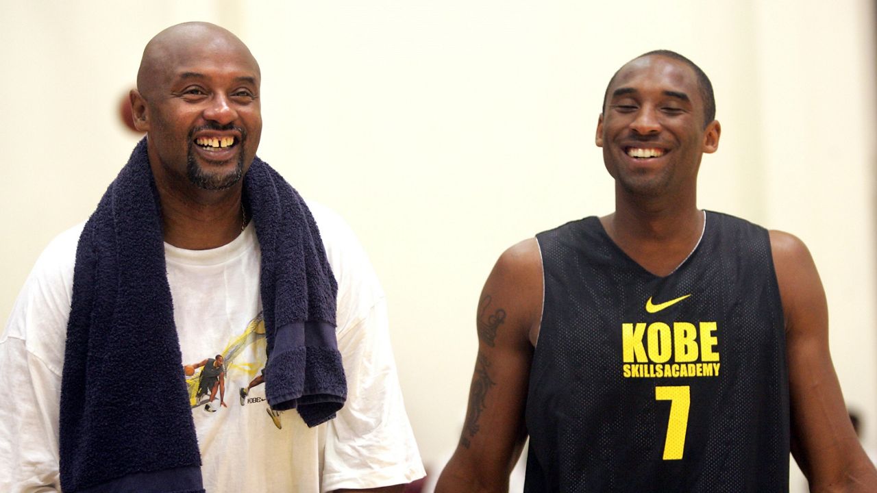 Los Angeles Lakers’ Kobe Bryant, right, has a laugh with his father, Joe “Jellybean” Bryant, prior to participating in a pickup basketball game at the  Kobe Bryant Basketball Academy at Loyola Marymount University in Westchester, Calif., on July 5, 2007. (AP Photo/Branimir Kvartuc)