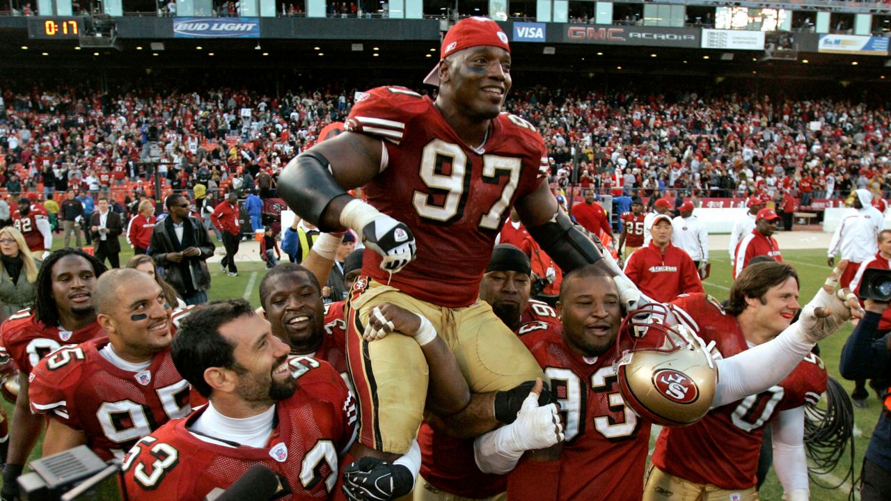 San Francisco 49ers defensive end Bryant Young (97) is carried off the field by teammates after his team's win over the Tampa Bay Buccaneers in an NFL football game in San Francisco, on Dec. 23, 2007. (AP Photo/Marcio Jose Sanchez, File)
