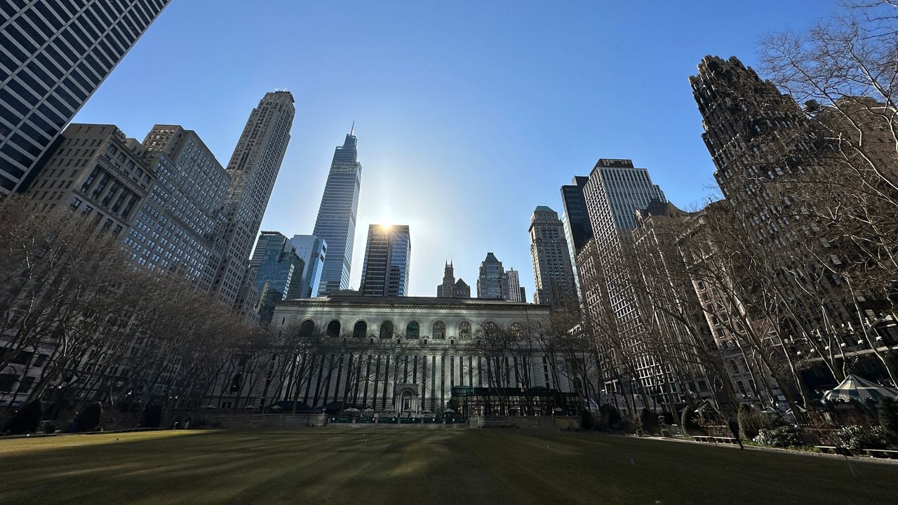 Bryant Park is pictured as the Manhattan skyline is seen in the background.