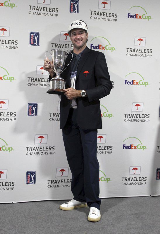 Bubba Watson poses for photos with the trophy after winning the Travelers Championship golf tournament, Sunday, June 24, 2018, in Cromwell, Conn. (AP Photo/Stew Milne)