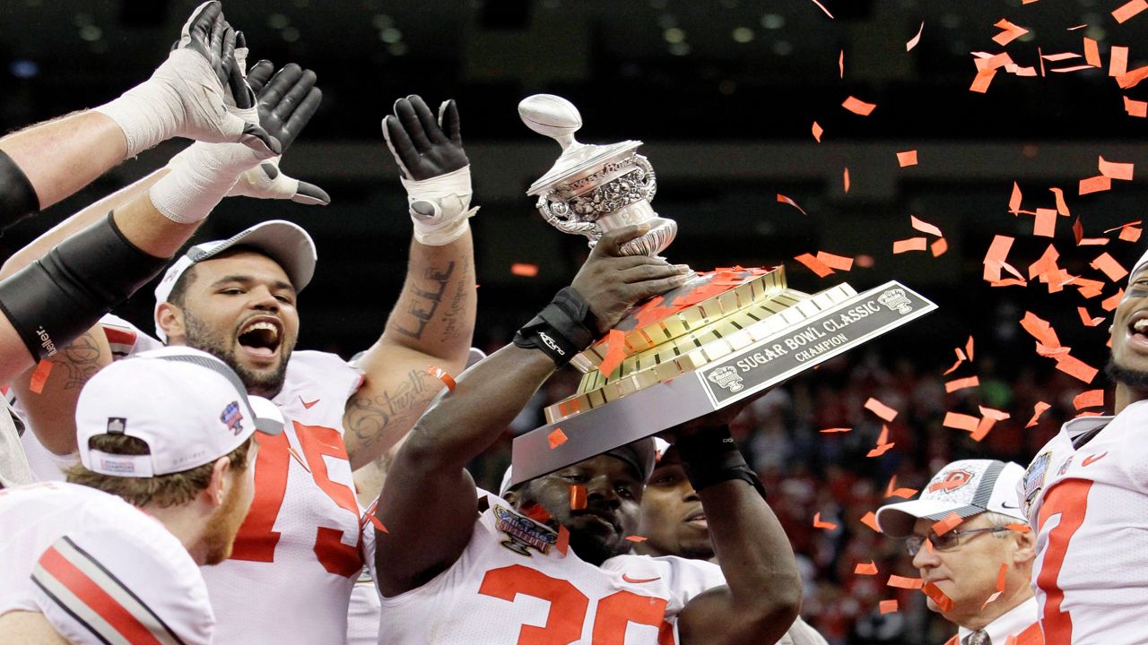 Ohio State linebacker Brian Rolle (36) holds up the Sugar Bowl trophy after they defeated Arkansas 31-26 during the Sugar Bowl NCAA college football game at the Louisiana Superdome in New Orleans, on Jan. 4, 2011. The 2010 season of the Ohio State University football team, vacated after a memorabilia-for-cash scandal, should be restored because of recent changes allowing college athletes to be compensated, under a symbolic resolution approved by Ohio lawmakers, Wednesday, May 18, 2022. (AP Photo/Patrick Semansky, File)
