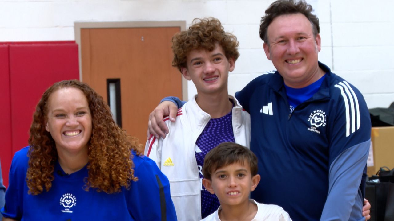 The Buckley family poses for pictures at FIFA volunteer check-in. From right to left: Taryn Buckley, Xavier Buckley and Dante Buckley. (Spectrum Sports 360/Brandon Green)