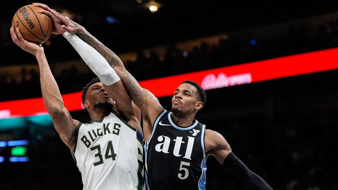 Milwaukee Bucks forward Giannis Antetokounmpo (34) shoots against Atlanta Hawks guard Dejounte Murray (5) 