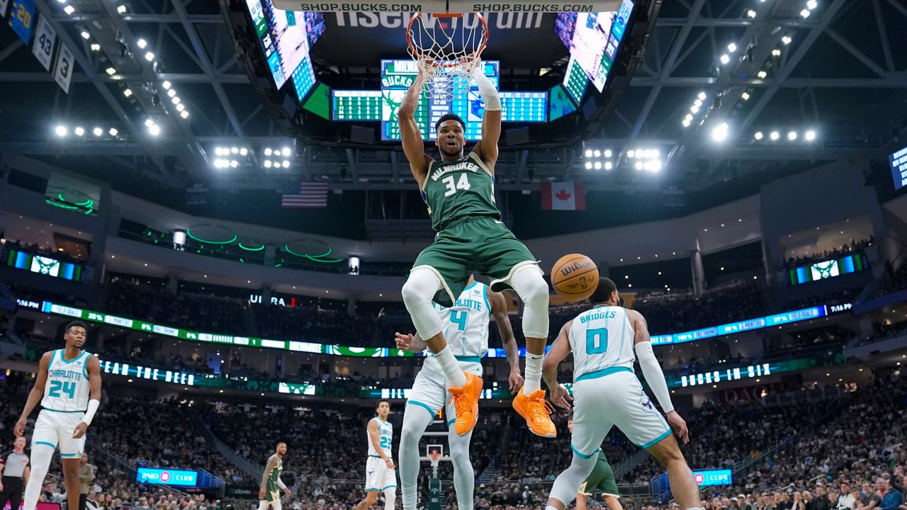 Milwaukee Bucks' Giannis Antetokounmpo dunks during the first half of an NBA basketball game