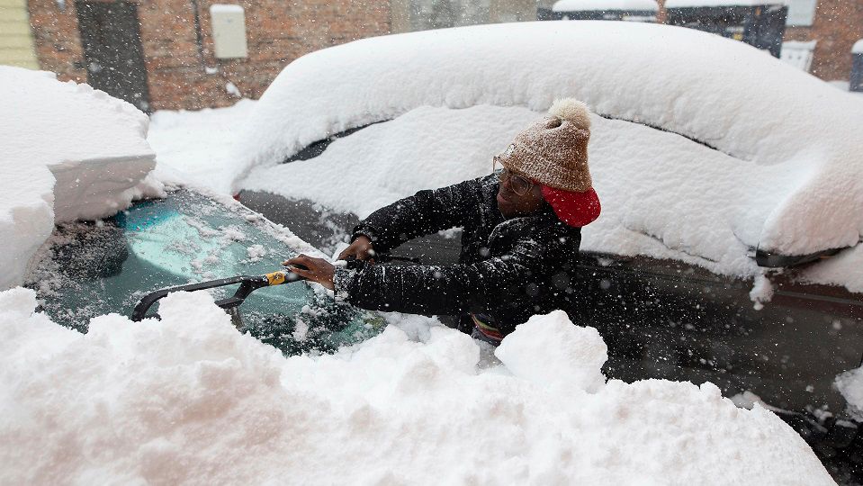 Clearing snow off vehicle