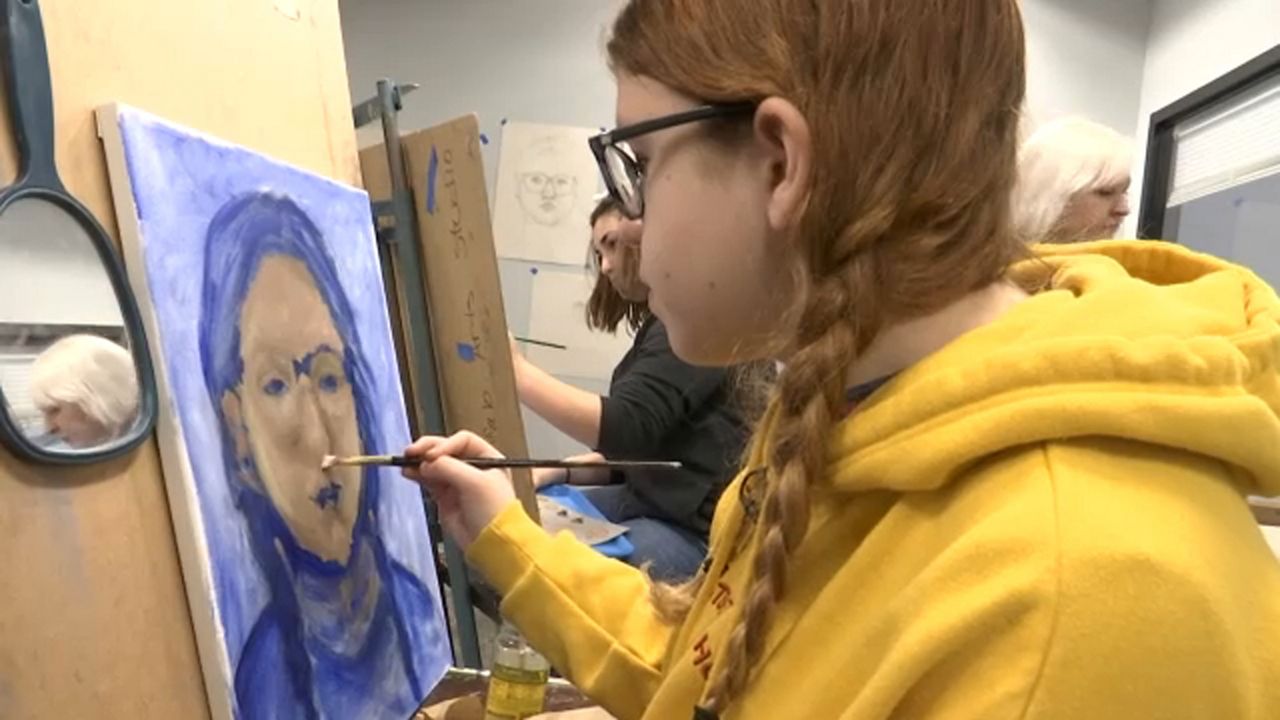 A child painting at the Buffalo Art Studio