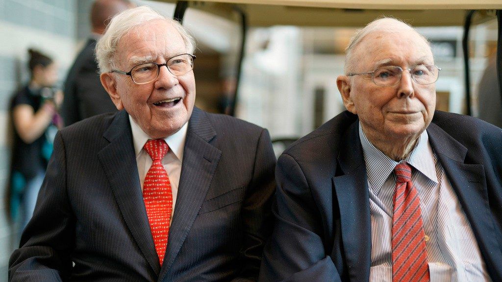 In this May 3, 2019 file photo, Berkshire Hathaway Chairman and CEO Warren Buffett, left, and Vice Chairman Charlie Munger, briefly chat with reporters before Berkshire Hathaway's annual shareholders meeting. (AP Photo/Nati Harnik, File)