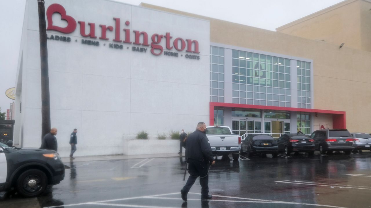 Police officers work at the scene where two people were struck by gunfire in a shooting at the Burlington Coat Factory store in North Hollywood, Calif., Thursday, Dec. 23, 2021. (AP Photo/Ringo H.W. Chiu)
