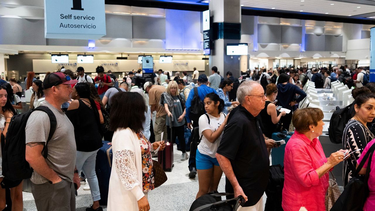 Passengers make their way toward security at Bush Intercontinental Airport Tuesday, July 9, 2024, in Houston. (Jason Fochtman/Houston Chronicle via AP, File)