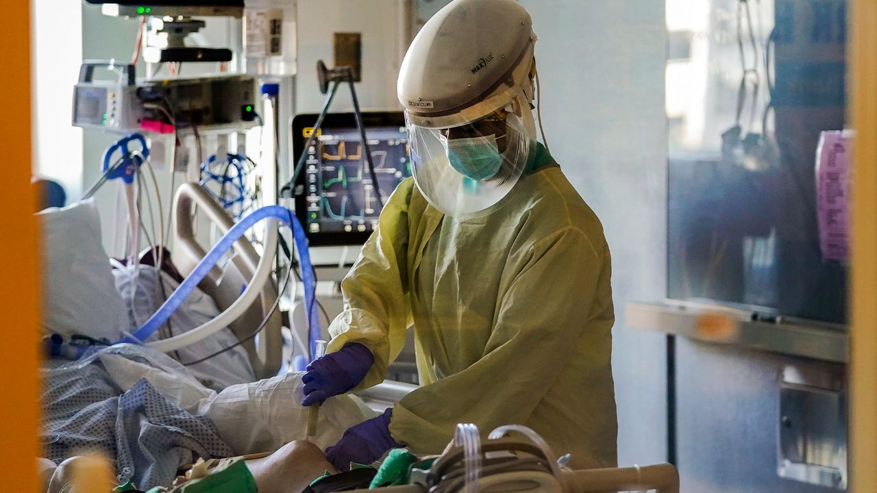 In this Wednesday, Jan. 13, 2021 file photo, a healthcare worker tends to a COVID-19 patient in the intensive care unit at Santa Clara Valley Medical Center during the coronavirus pandemic in San Jose, Calif. (AP Photo/Jeff Chiu, File)