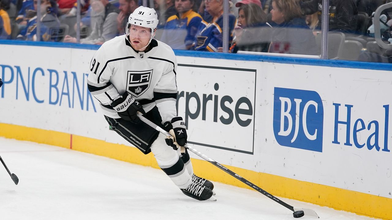 Los Angeles Kings’ Carl Grundstrom controls the puck during the third period of an NHL hockey game against the St. Louis Blues Monday, Oct. 25, 2021, in St. Louis. (AP Photo/Jeff Roberson)