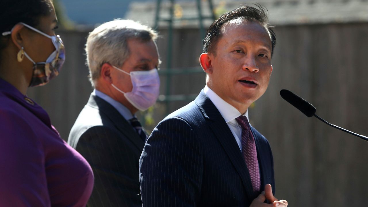San Francisco City Attorney David Chiu, right, stands next to Mayor London Breed, left, and former City Attorney Dennis Herrera as he speaks during a news conference on Sept. 29, 2021, in San Francisco. Opioid makers Allergan and Teva have agreed to pay $54 million in cash and overdose reversal drugs to settle a federal lawsuit brought by San Francisco. The city alleges the drug industry fueled an overdose and addiction surge in San Francisco that created a public nuisance. (Lea Suzuki/San Francisco Chronicle via AP, File)