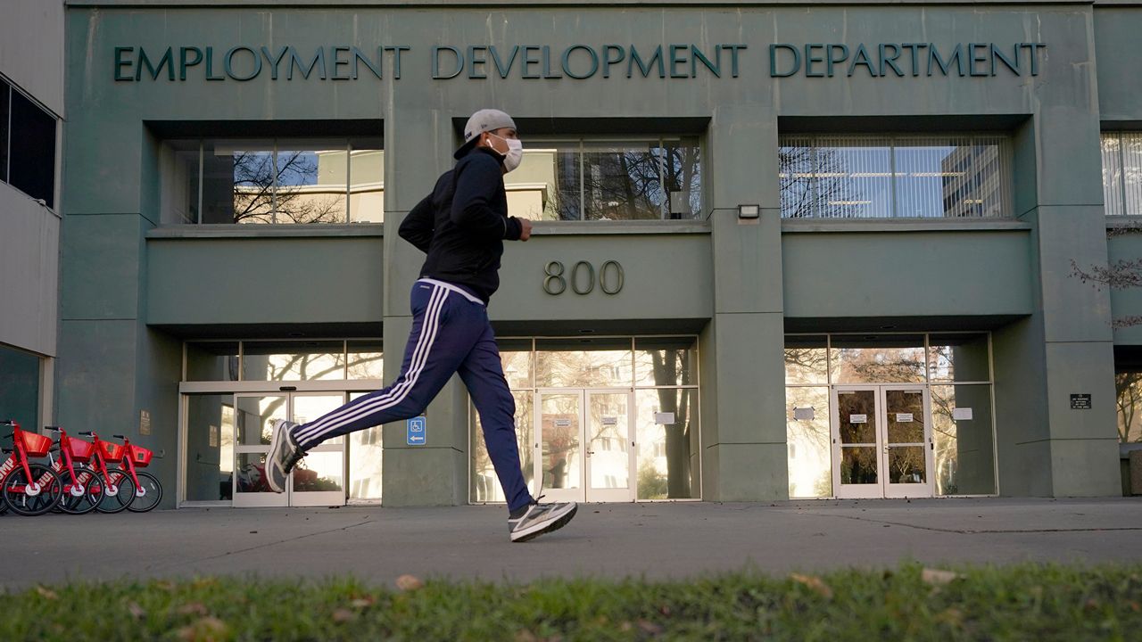In his Dec. 18, 2020, file photo, a runner passes the office of the California Employment Development Department in Sacramento, Calif. (AP Photo/Rich Pedroncelli, File)
