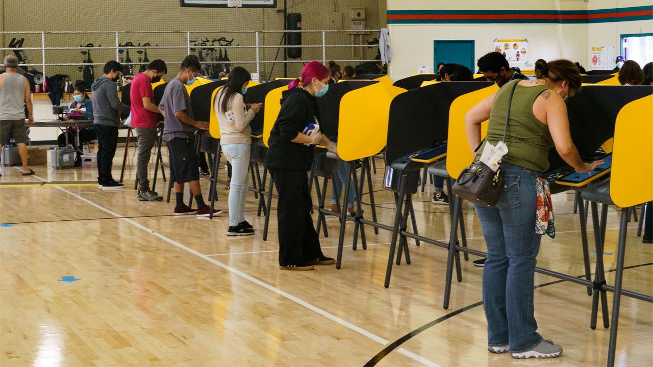 Voters fill out ballots on Election Day inside the Ruben F. Salazar Park recreation center, Tuesday, Nov. 3, 2020, in Los Angeles. (AP Photo/Damian Dovarganes)