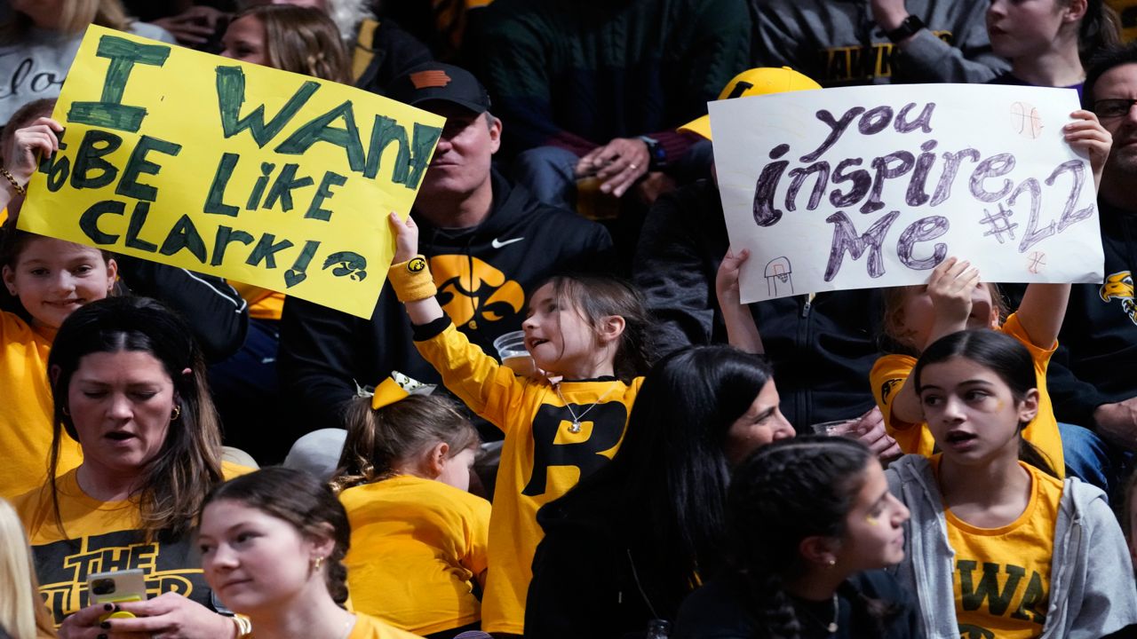 Supporters hold signs for Iowa guard Caitlin Clark before an NCAA college basketball game between Iowa and Northwestern in Evanston, Ill., Wednesday, Jan. 31, 2024.