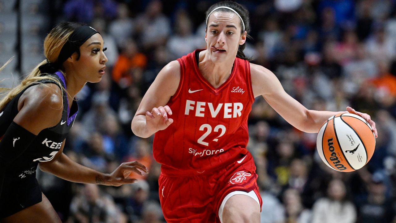 Indiana Fever guard Caitlin Clark (22) drives to the basket as Connecticut Sun guard DiJonai Carrington defends during a first-round WNBA basketball playoff game, Wednesday, Sept. 25, 2024, in Uncasville, Conn. (AP Photo/Jessica Hill)