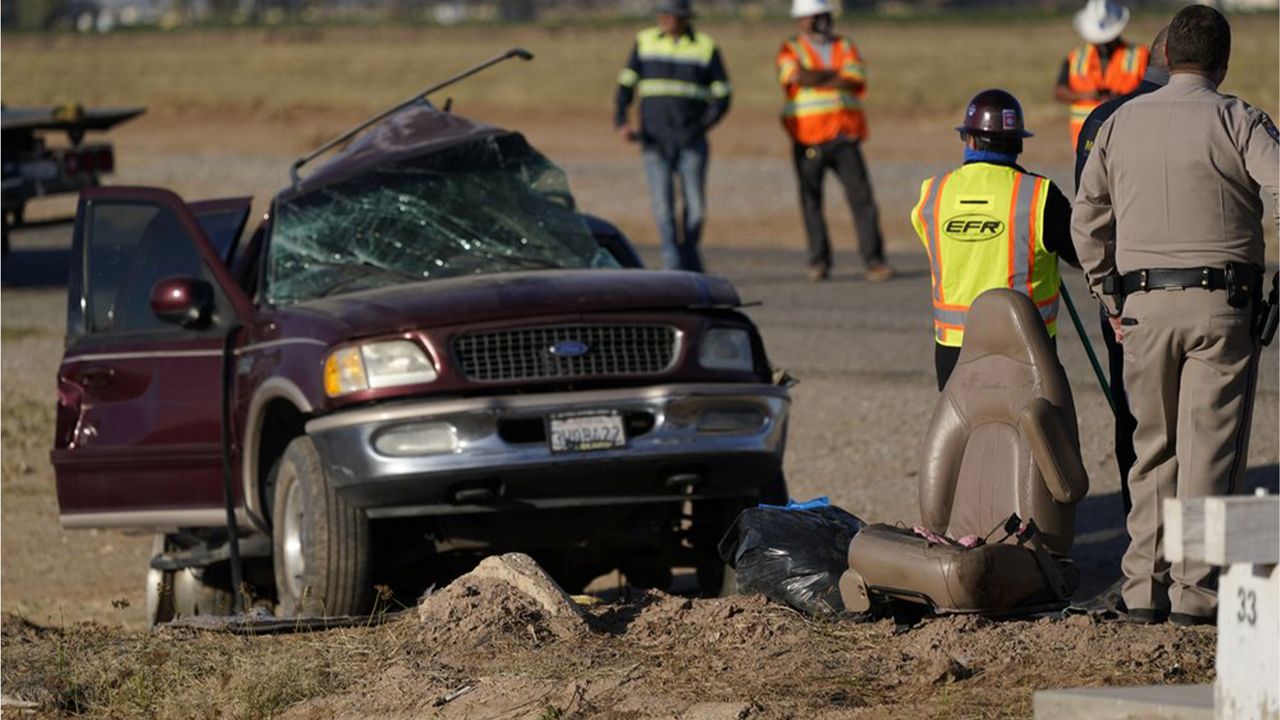 FILE - In this March 2, 2021 file photo law enforcement officers sort evidence and debris at the scene of a deadly crash in Holtville, Calif. (AP Photo/Gregory Bull, File)