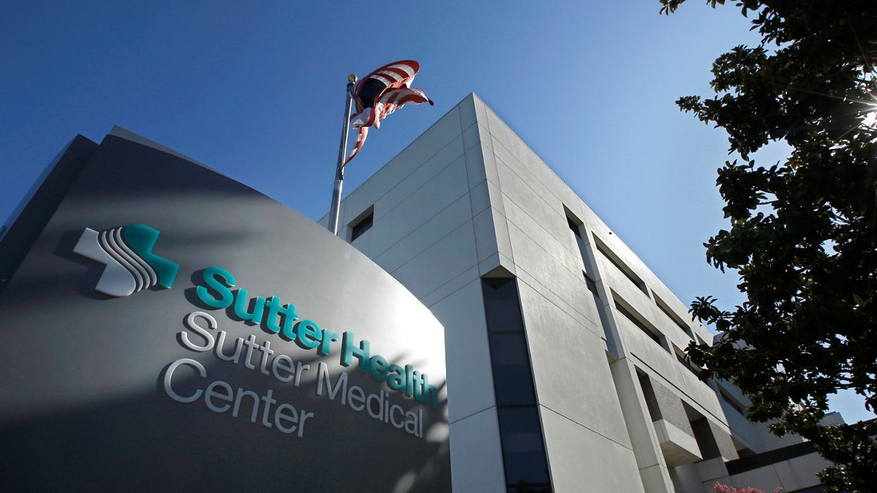 The FILE - An American flag flutters in the breeze outside of the Sutter Medical Center in Sacramento, Calif., Sept. 20, 2019. On Wednesday, Feb. 8, 2023, the UCLA Center for Health Policy Research said a five-year experiment to improve care for some of California's most at-risk Medicaid patients resulted in fewer hospitalizations and emergency room visits. (AP Photo/Rich Pedroncelli, File)Health and Nutrition Examination Survey has four trailers for its mobile testing center which are currently located at the fairgrounds in Orange County. (Spectrum News/William D'Urso)