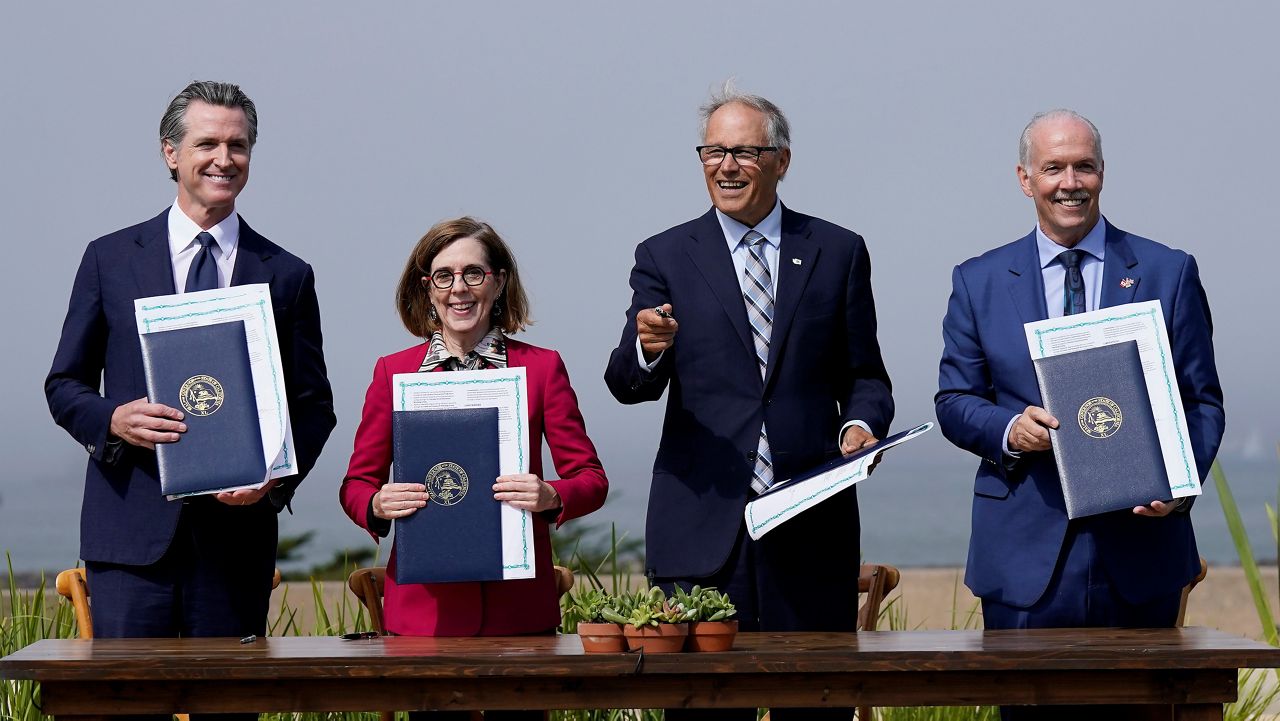 California Governor Gavin Newsom, from left, poses for photos after signing a new climate agreement with Oregon Governor Kate Brown, Washington Governor Jay Inslee and British Columbia Premier John Horgan at the Presidio Tunnel Tops in San Francisco, Thursday, Oct. 6, 2022. (AP Photo/Jeff Chiu)