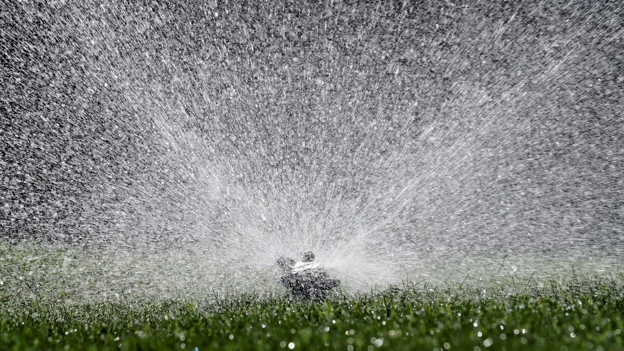 Water flies from a sprinkler watering a lawn, in Sacramento, Calif., May 10, 2022. (AP Photo/Rich Pedroncelli)