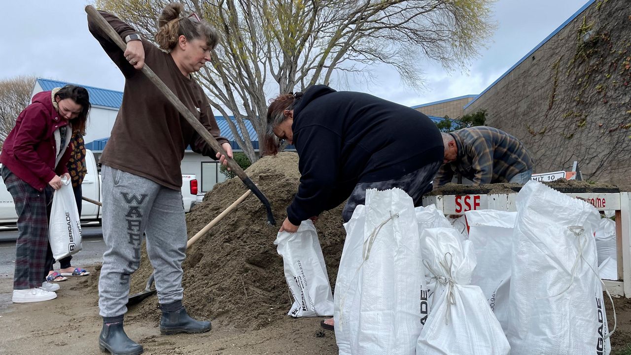 People fill sandbags in preparation for the next storms outside a public works station in South San Francisco, Calif., Tuesday, Jan. 3, 2023. (AP Photo/Haven Daley)