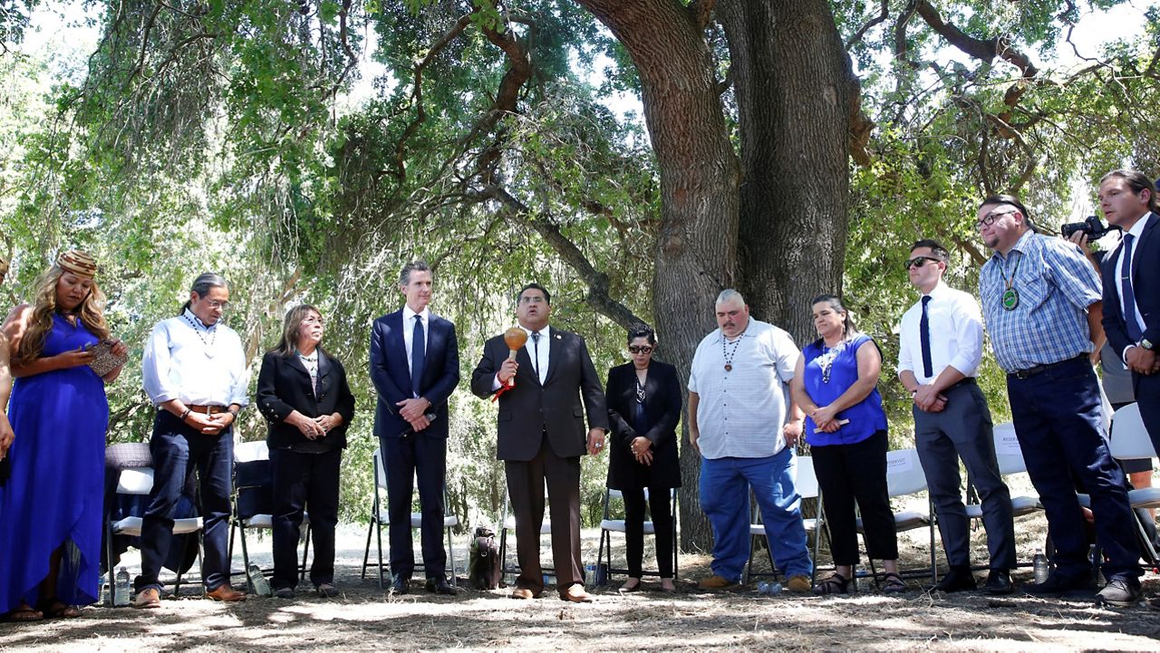 Assemblyman James Ramos, D-Highlands, of the San Manuel Band of Mission Indians, fifth from left, opens a meeting with tribal leaders from around the state, attended by Gov. Gavin Newsom, fourth from left, at the future site of the California Indian Heritage Center in West Sacramento, Calif. (AP Photo/Rich Pedroncelli, File)