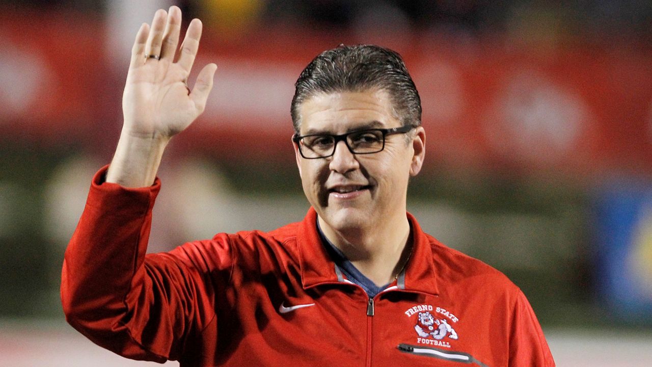 In this Nov. 4, 2017 file photo, Fresno State president Joseph I. Castro waves to the crowd before an NCAA college football game against BYU in Fresno, Calif. (AP Photo/Gary Kazanjian, File)